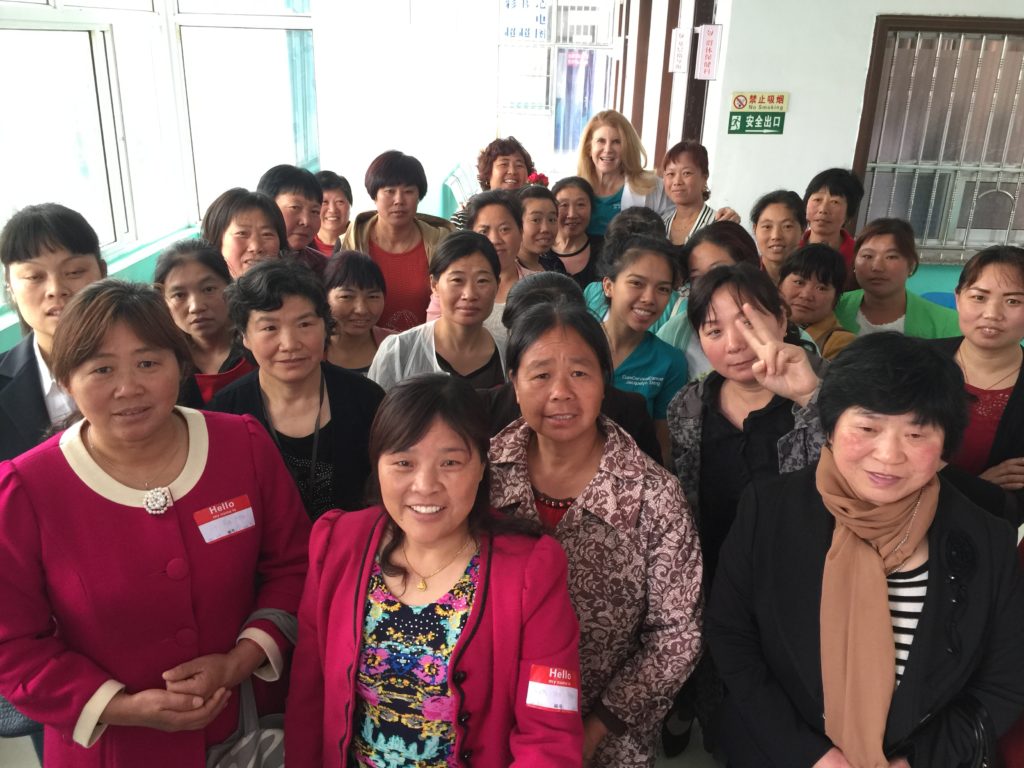 Dr. Patricia Gordon standing with newly trained health professionals in China in  2015.