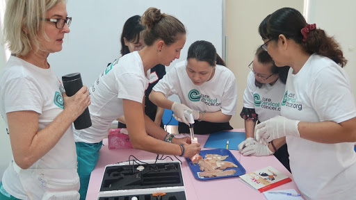 CCC Program Manager Imma Bramlage demonstrates application of the thermal ablation device on pieces of raw chicken.